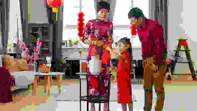 Family wearing red at home to celebrate the Lunar New Year.