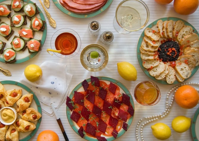 “On buffet tables, garnished with glistening hors-d’oeuvre, spiced baked hams crowded against salads of harlequin designs and pastry pigs and turkeys bewitched to a dark gold.”