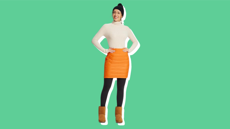 A model wears an orange puffer skirt.
