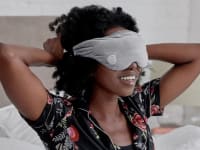 Person with weighted eye mask over eyes.
