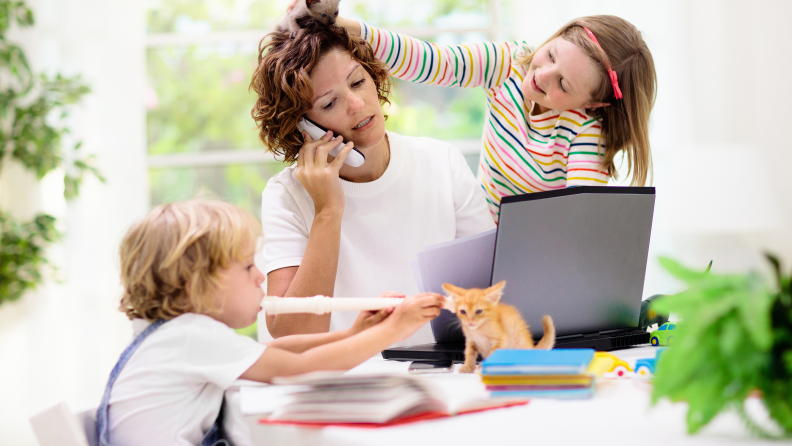 Mom on phone with two annoying kids