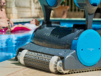 Close-up of a blue and gray Dolphin Premier robotic pool cleaner.