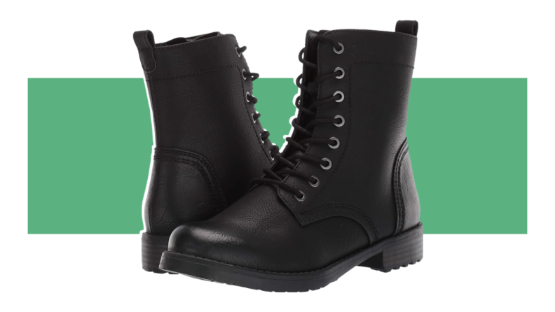 A pair of black Amazon Essentials Collins Lace-Up Combat Boot displayed in front of a green stripe background.