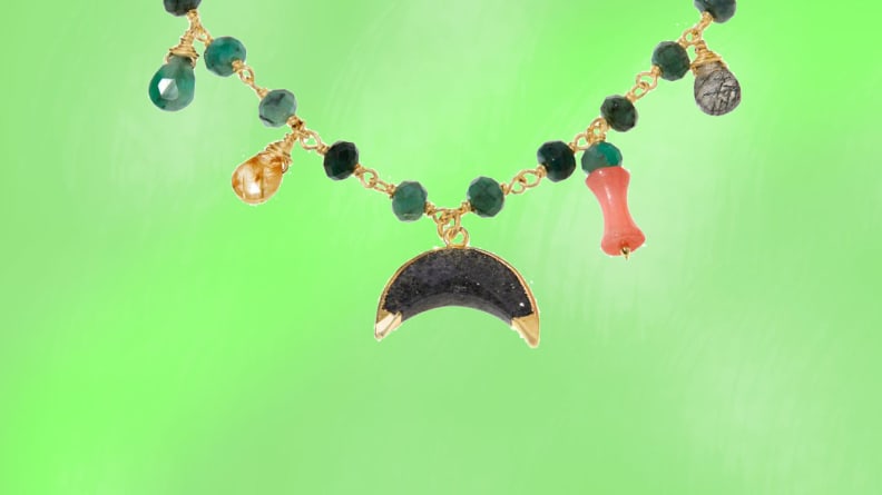 An emerald necklace in front of a green background.