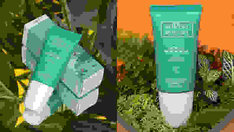 On the left: The Selfless by Hyram Retinol & Rainbow Algae Repair Serum in its blue tub laying on top of its box packaging on a grassy background. On the right: The same blue serum bottle standing amongst grass on an orange background.