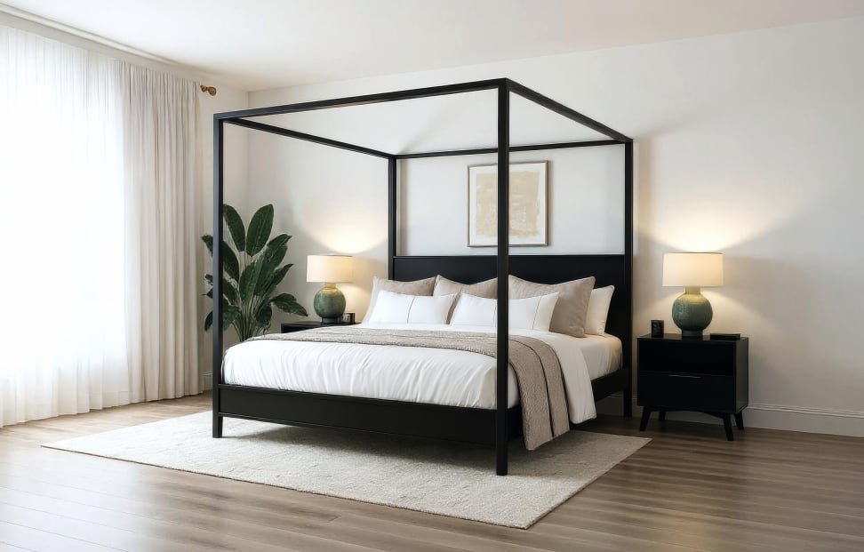A black wooden canopy bed from Plank+Beam