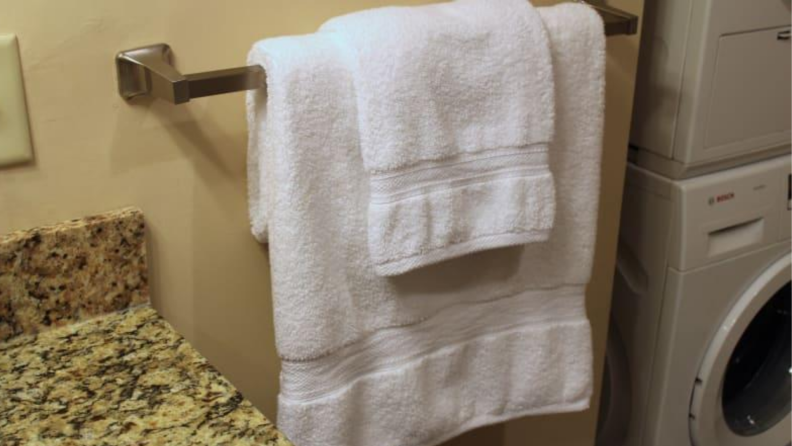 Two bath towels hanging on a towel rack