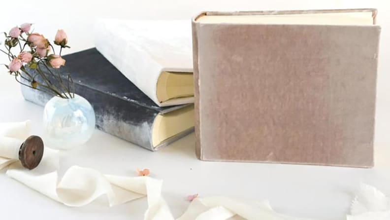 Velvet wedding album on a table.