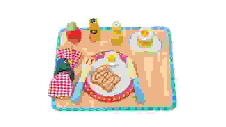 Wooden toy breakfast set with plate, fork, knife, napkin and an egg