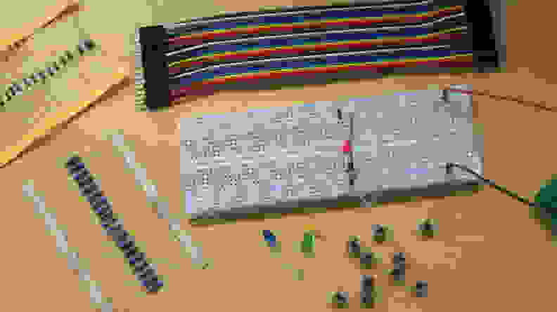 Components of the Boolean Box include a breadboard, wires, resistors, push buttons, and LEDs.