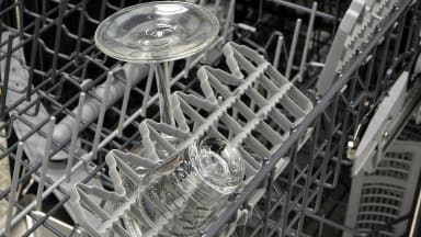 Thermador Emerald upper rack fold-down shelves loaded with a shot glass and a wine glass