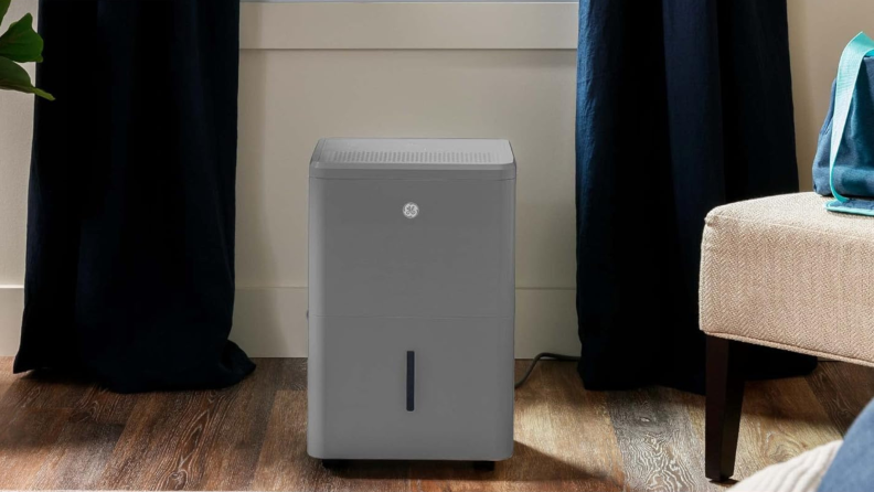 A grey ge dehumidifier sits on a floor
