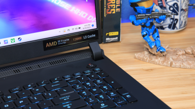 Asus ROG Strix laptop sitting on desk surface with the AMD Ryzen 9 7945HX3D chip.