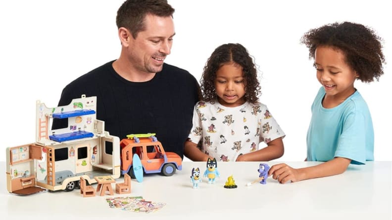 Father playing with two young children.