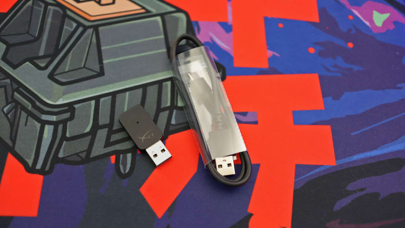 A close up of a USB cable wrapped in plastic and a small USB wireless adapter