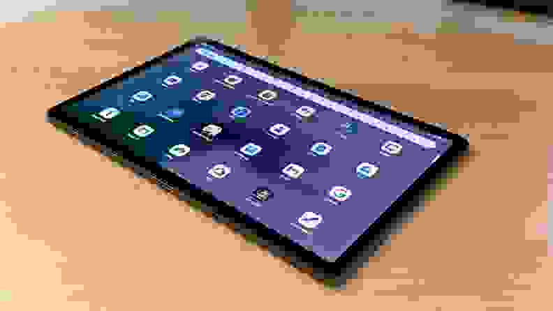 A Tab P11 Pro Gen 2 tablet sits on a desk with its display turned on, app icons ready to poke at.