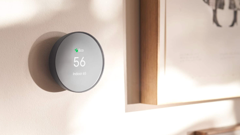 A smart thermostat against a wall.