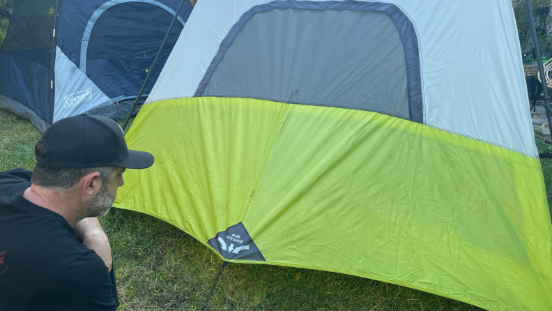 A man pulls at the side of a Core tent.