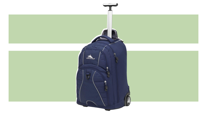 The High Sierra Freewheel Wheeled Laptop backpack on a green background.
