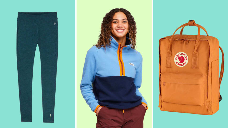 An image of a set of navy leggings, a model wearing a light blue and dark blue Cotopaxi pullover with orange trim, and an orange Fjallraven backpack.