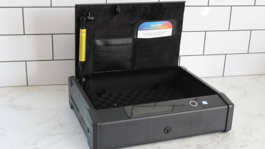 The Lockly Smart Safe with the lid open on a marble counter.