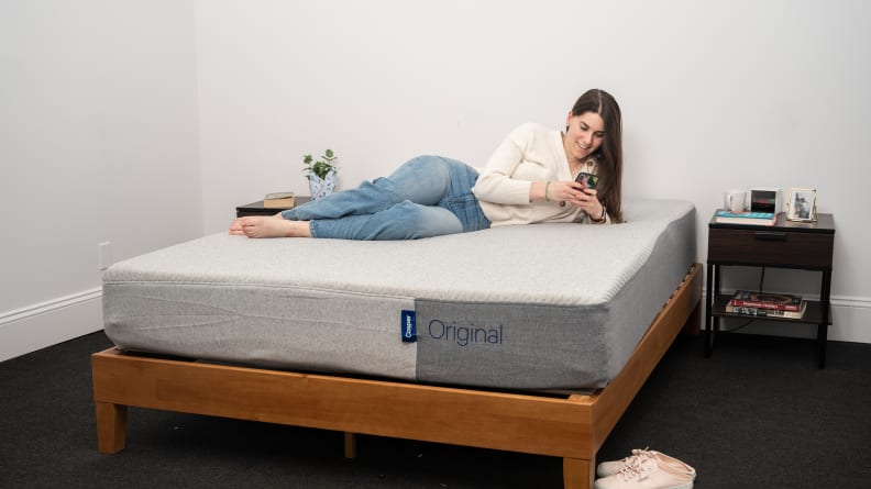 a person sits on the casper original mattress