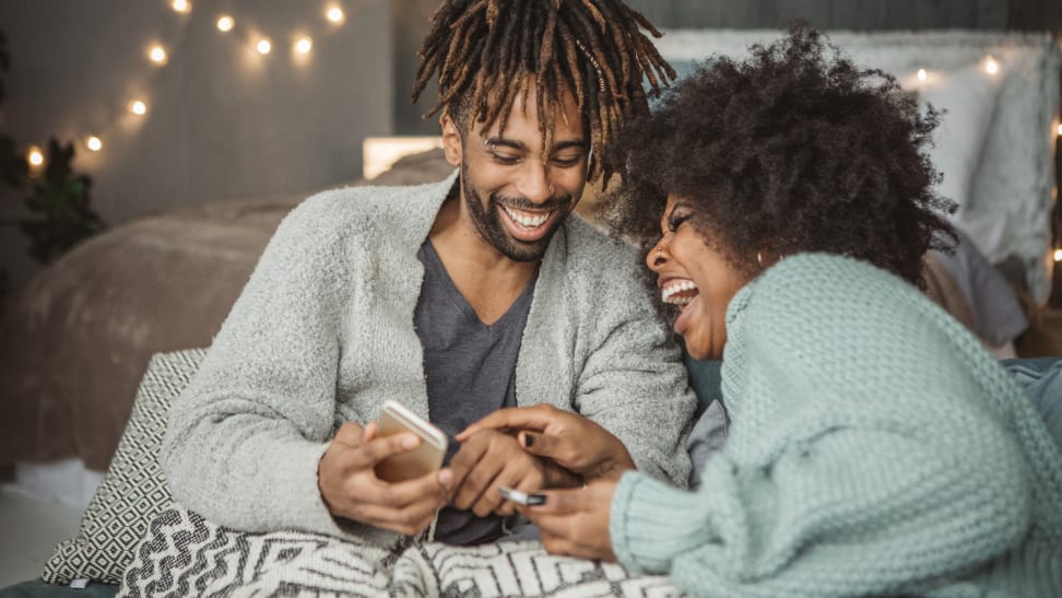 This couple looks joyful about supporting Black-owned businesses online.