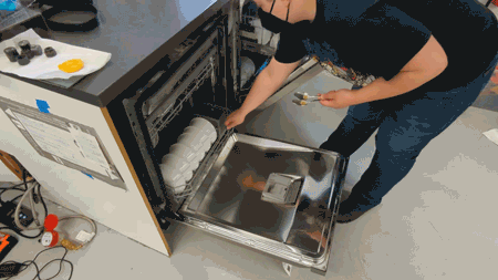 Animated GIF of someone putting dishes in a dishwasher.