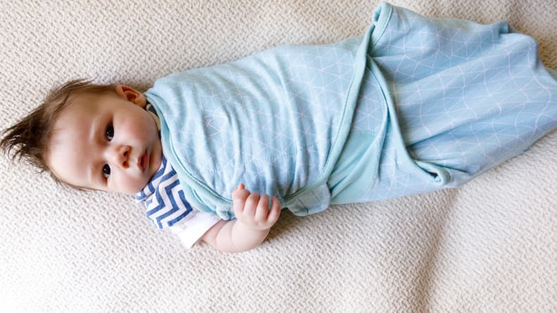 Baby wrapped in a blue swaddle