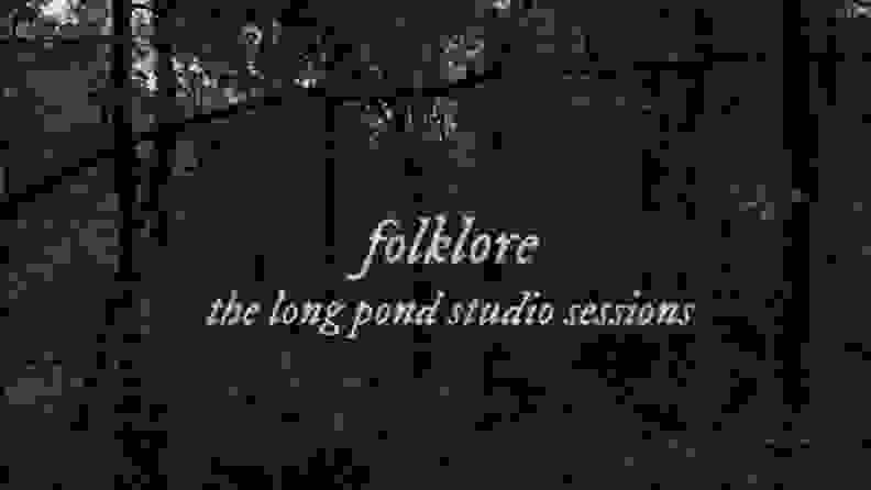 The title card for 'Folklore' featuring the title against a background of trees.