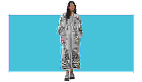 A model wearing a white and blue printed maxi dress.