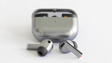 The Samsung Galaxy Buds3 Pro earbuds in front of its charging case.