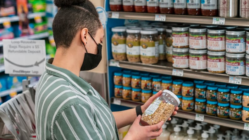 A person reads nutritional value on a packaged product.