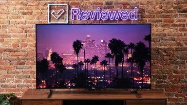The Hisense U8H LED TV on display in the Reviewed labs with what appears to be Los Angeles at night time on the screen.