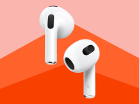 Close up of the newest Apple AirPods against a red background.