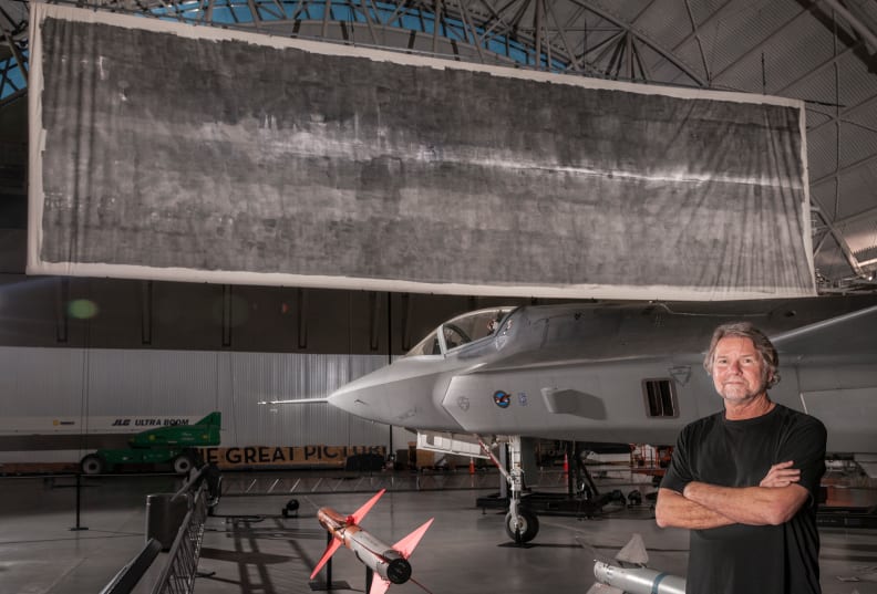 Artist Jacques Garnier stands in front of The Great Picture