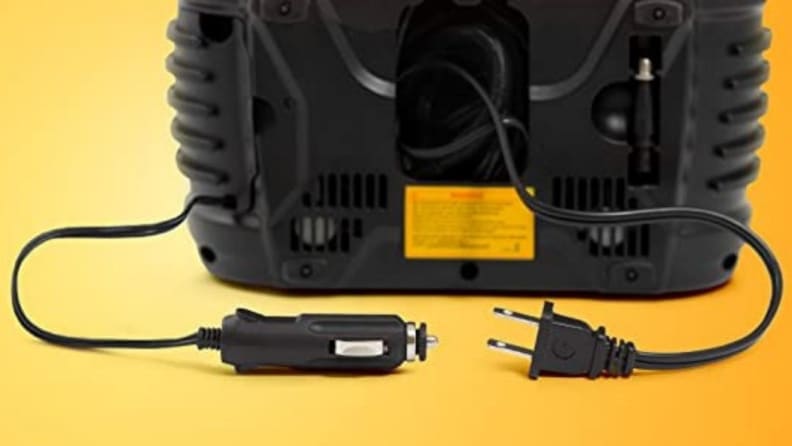 Wall plug and lighter adaptor of air compressor on yellow background