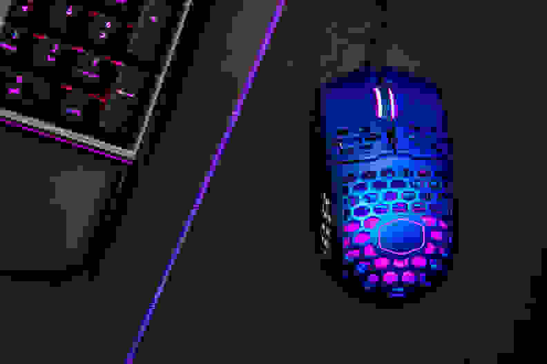 A computer mouse next to a keyboard