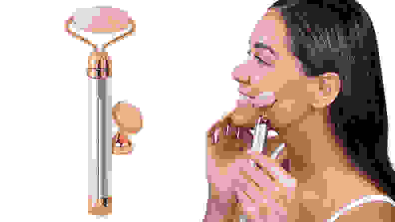 Woman using facial roller on face.