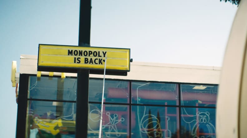 The exterior of a McDonalds and a sign reading, "Monopoly is back."