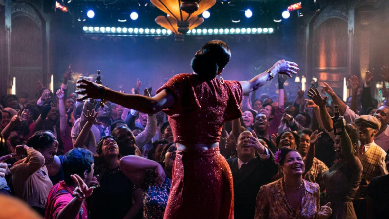 A still from the film The United States vs Billie Holiday featuring Billie Holiday as played by Andra Day performing onstage.