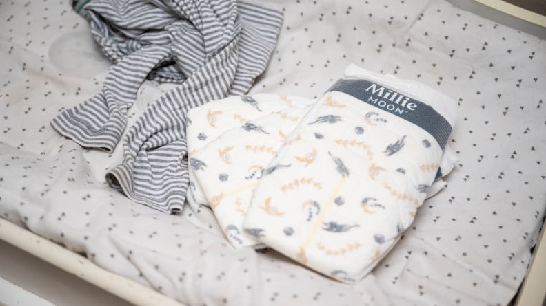 A pair of Millie Moon diapers on a changing table pad