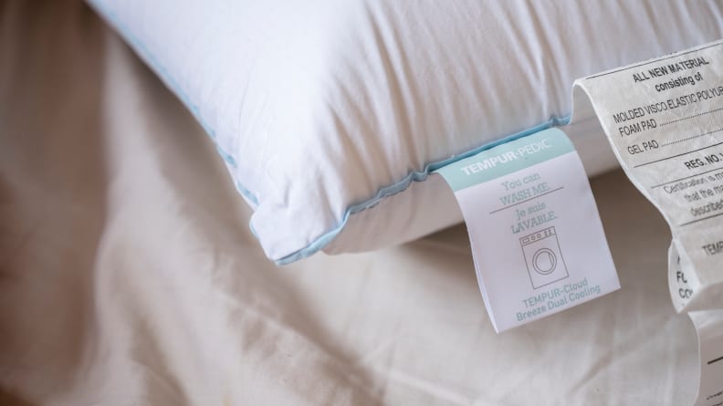 the Tempur-Cloud pillow tags on a bed surface