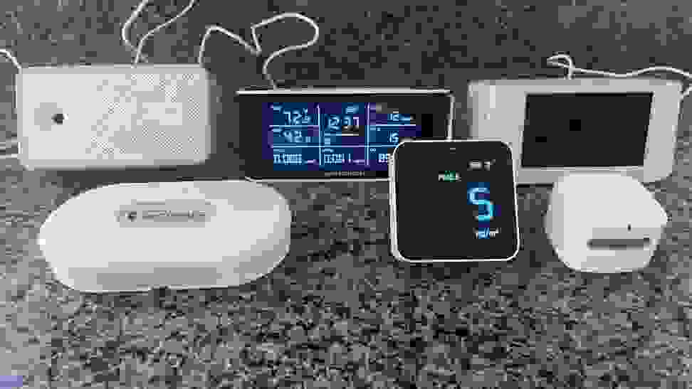 A group photo featuring the six indoor air quality monitors we tested sitting on a countertop