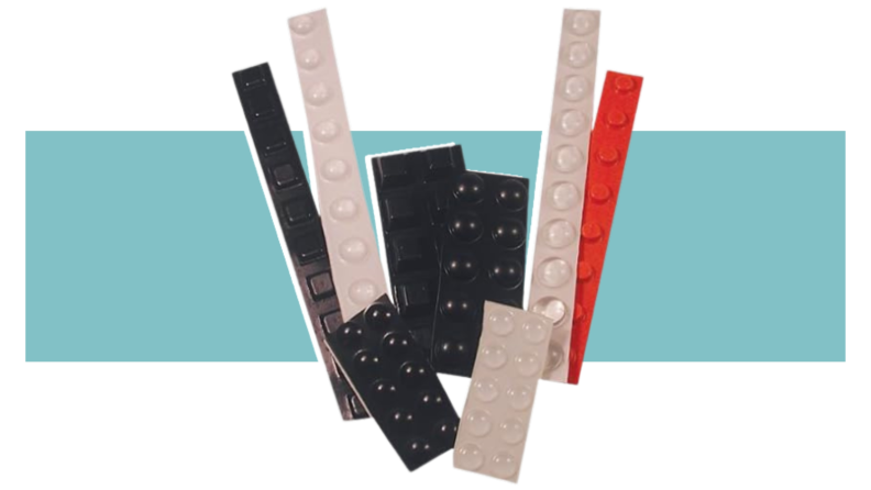 White, black, and orange raised bump dots on a colorful background