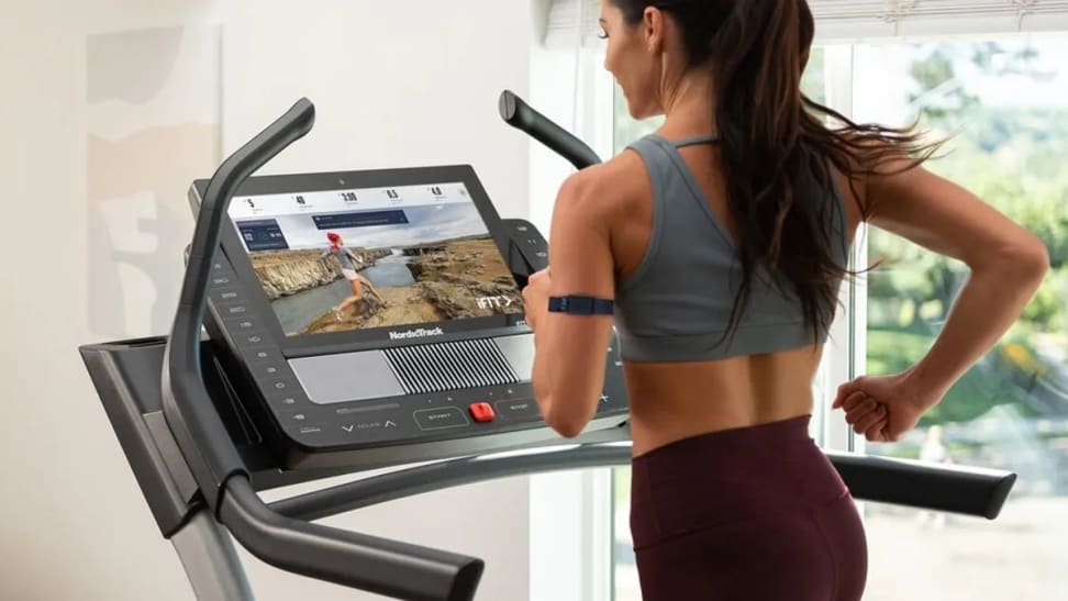 woman running on treadmill with screen