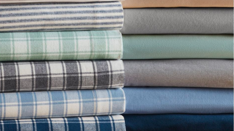 An image of stacked, folded topsheets in flannel.