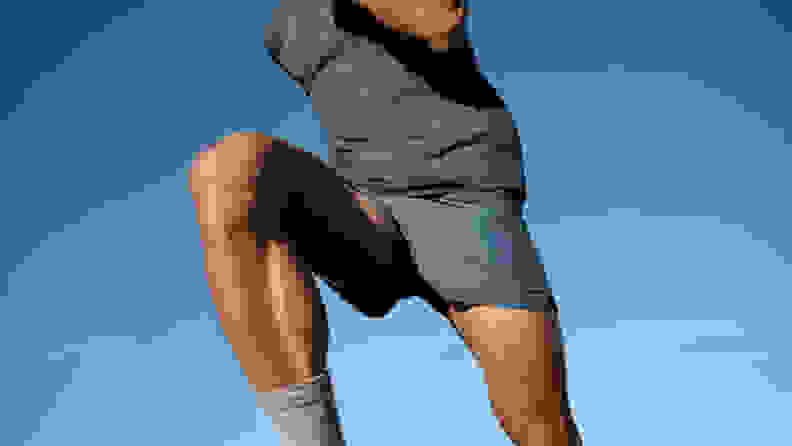 man wearing allbirds natural run shorts.