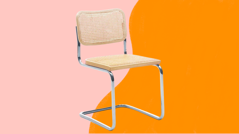 Cane and rattan chair against pink and orange background