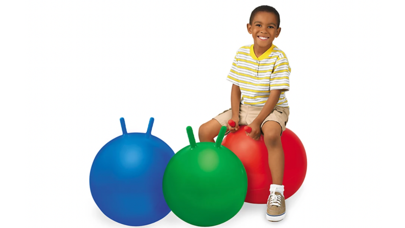 A child bounces on multicolored balls from Lakeshore.